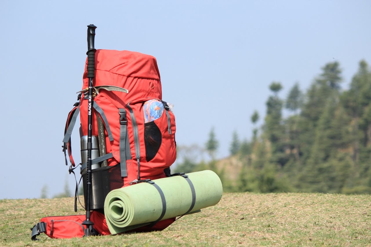  Red hiking backpack on green grass