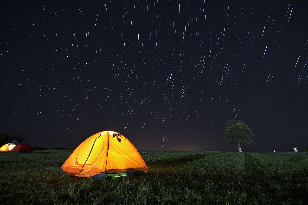 Yellow tent under a beautiful night sky
