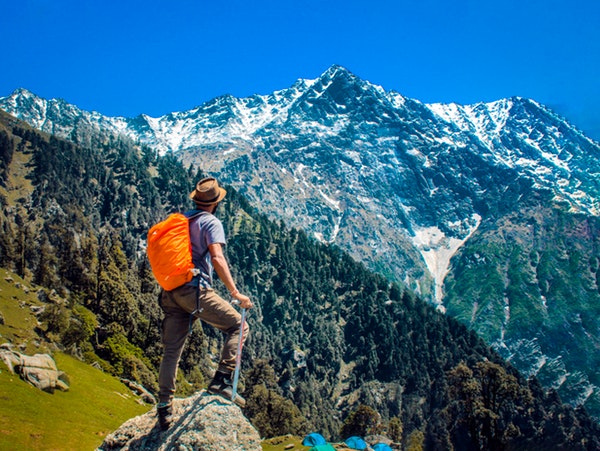 man standing on top of a rock