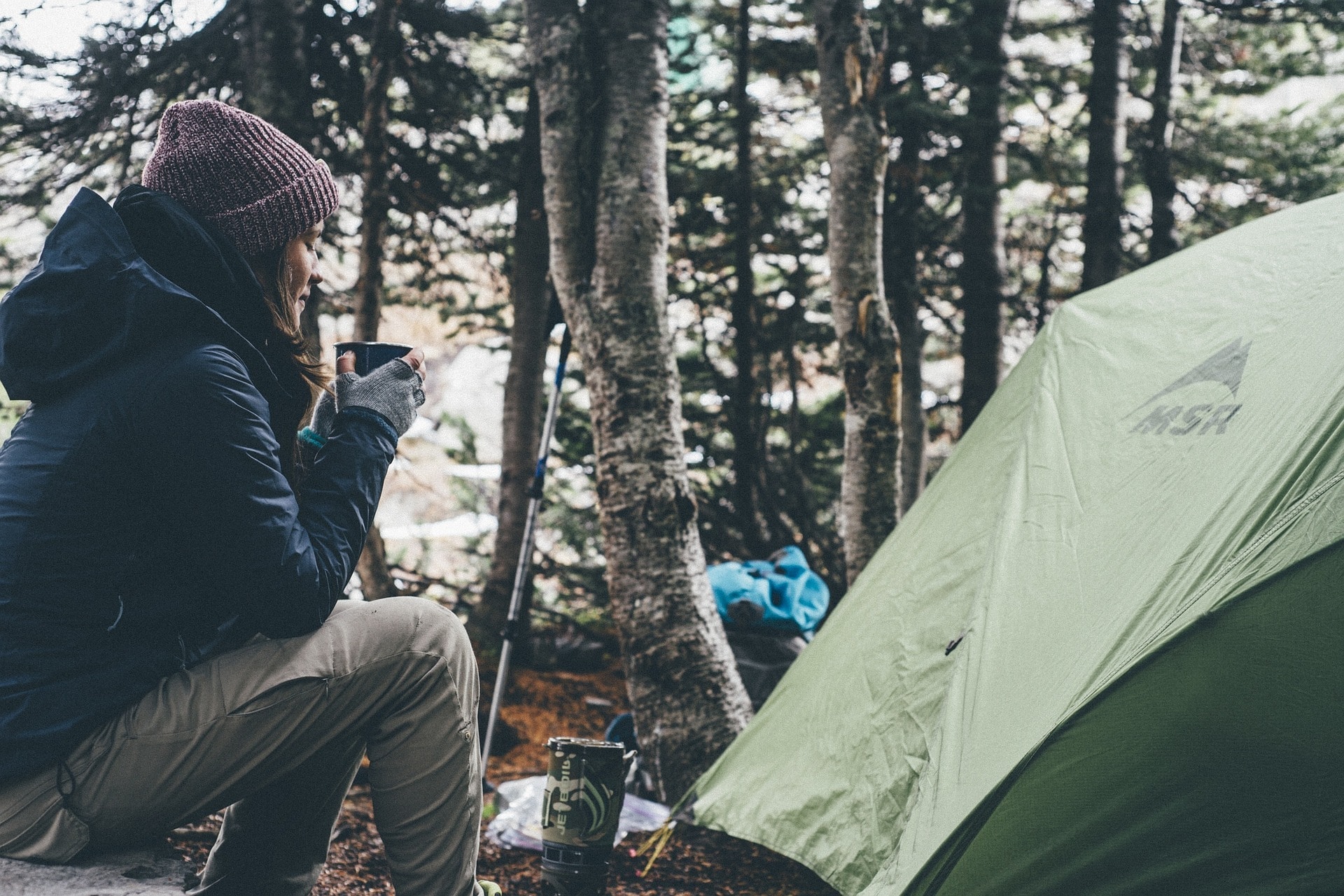 girl camping and drinking coffee