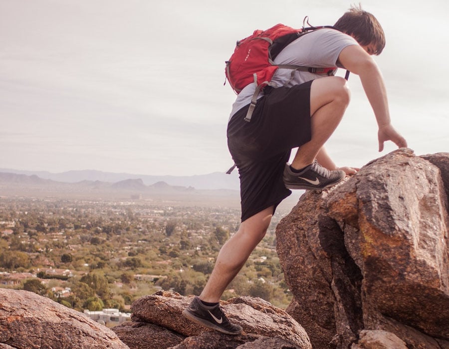 Hiker on the boulder wearing black nike hiking boots