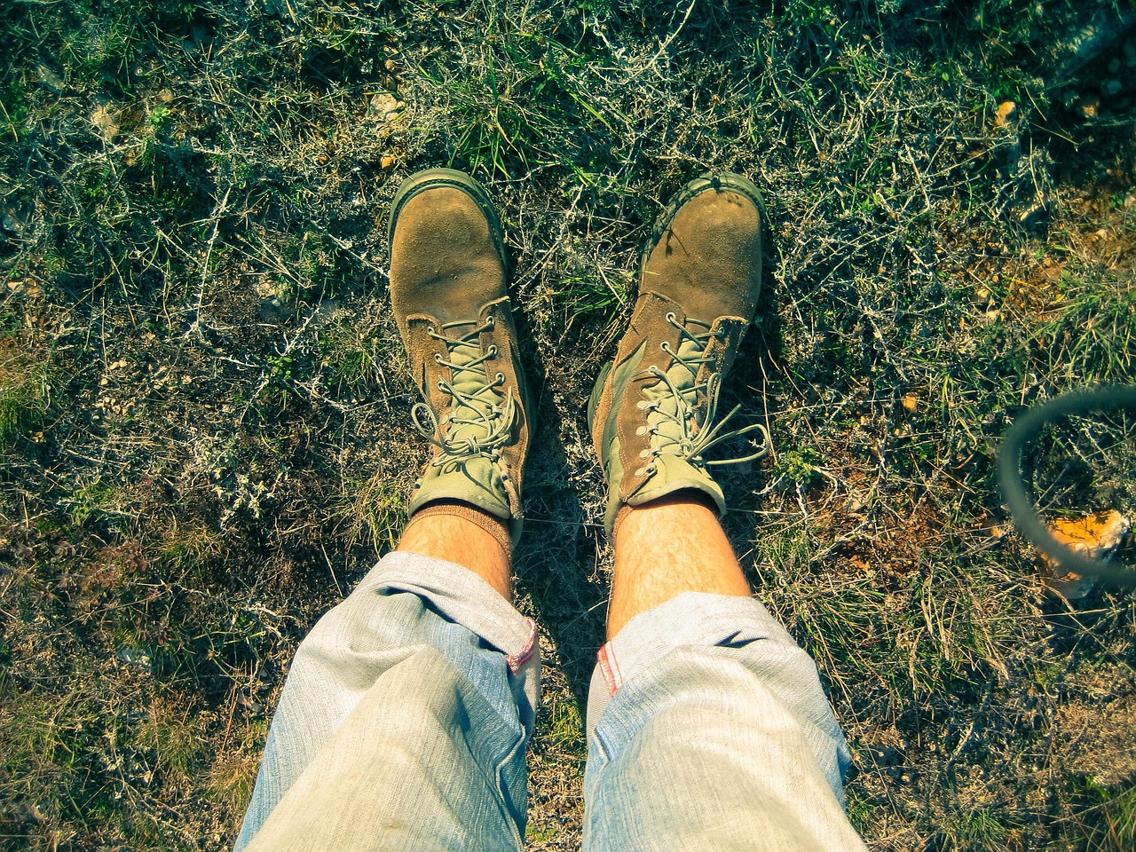 person standing on a grass wearing a brown shoes