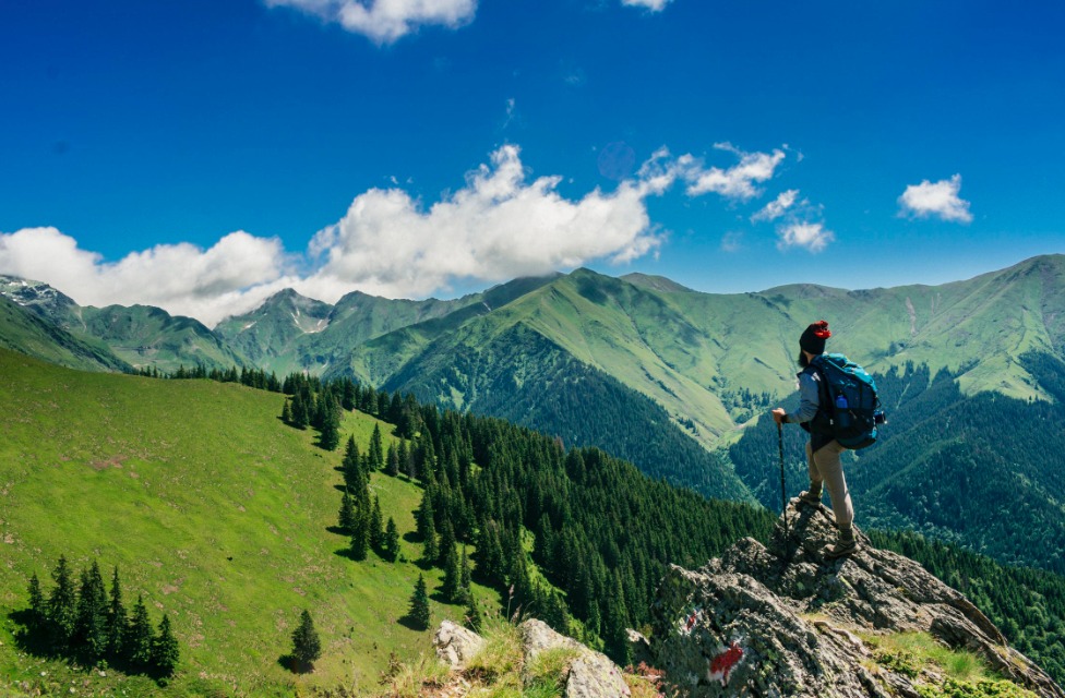 best hiking boots: man standing on a rock