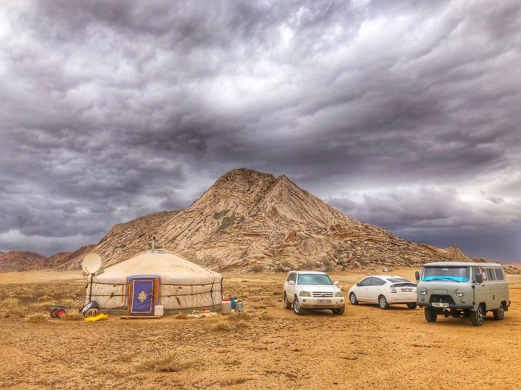 3 cars outside a tent