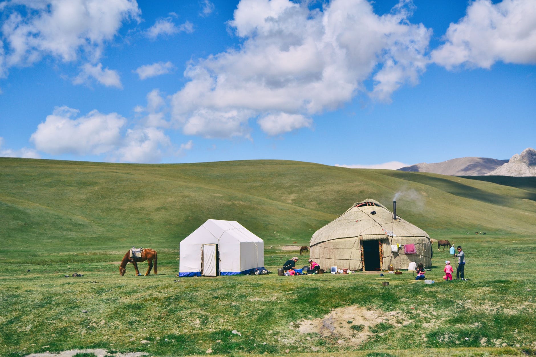 people doing chores outside their tents