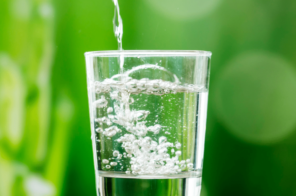 water pouring in clear drinking glass