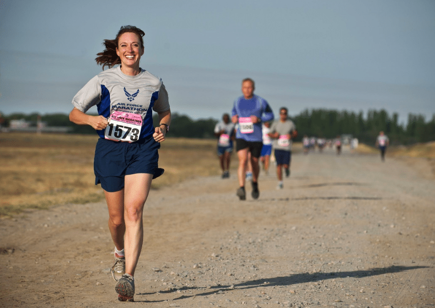 woman-in-gray-crew-neck-shirt-running-on-brown-soil-during-daytime woman in gray crew neck shirt running on brown soil during daytime
