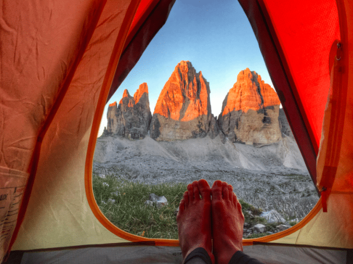 pitching a tent: camping environment feet grass